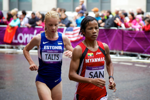 Two runners (one from Estonia and one from Myanmar) running at the Olympics